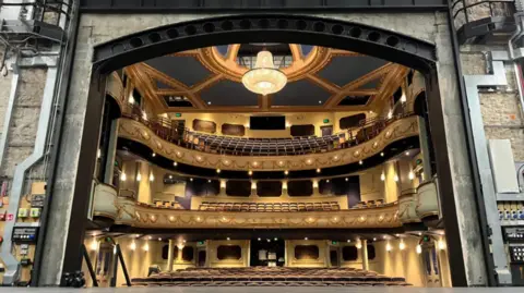 BBC The interior of the newly refurbished opera house from the viewpoint onstage of the stage floor and the auditorium.