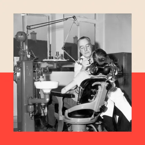 Getty A black-and-white image of a dentist treating a child