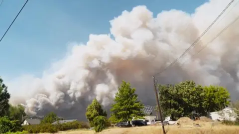Smoke billows into the sky during a wildfire in Washington state