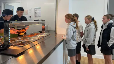 BBC Children at Ysgol Sant Baruc, Barry receiving school dinners made from local organic vegetables.