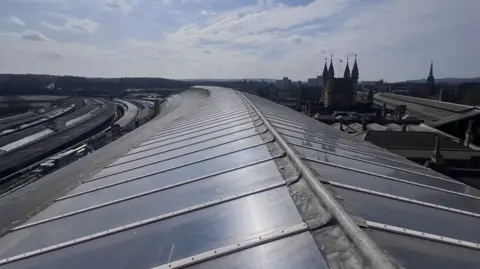 A view of the roof of the railway station, showing glazing panels and a lead strip along the top