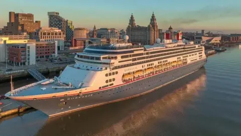 A large cruise ship berthed in Liverpool near to Liverpool Liver Building