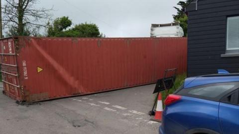 A lorry container fallen on the road