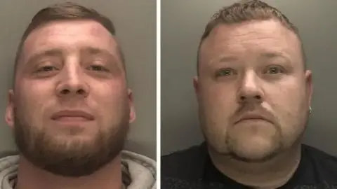 West Midlands Police Adam is smiling in his police mugshot and is wearing a grey hooded top. He has a beard. David also has a beard and earring in one ear. He is wearing a black top.