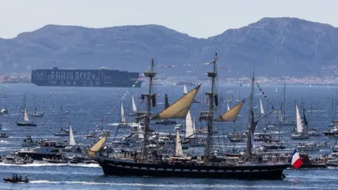 The Belem which is carrying the Olympic flame, is accompanied by other boats approaching Marseille, southern France on May 08, 2024