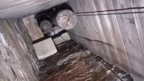 Supplied A view up a shaft where the weights dangle