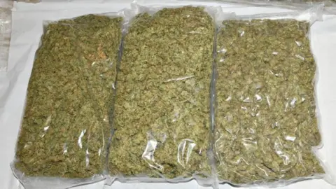 National Crime Agency Three reasonable sized clear bags of cannabis, photographed by investigators.