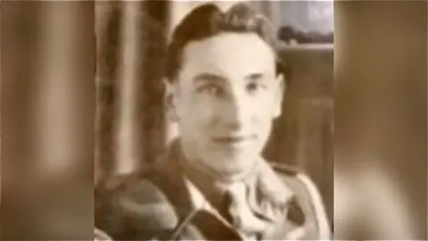 A faded photograph of Roy Burr, taken in the 1940's. It is sepia in colour, showing the image of a young man in army uniform posing with a slight smile for the camera.