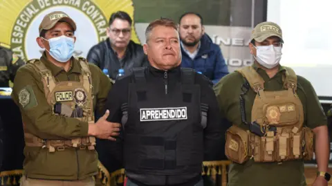 Reuters Bolivian General Juan Jose Zuniga stands with two police guards