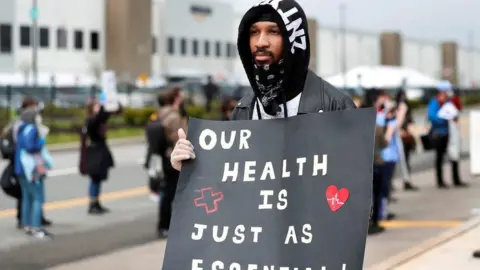 Reuters Former Amazon employee, Christian Smalls, stands with fellow demonstrators during a protest outside of an Amazon warehouse as the outbreak of the coronavirus disease (COVID-19) continues in the Staten Island borough of New York U.S., May 1, 2020.