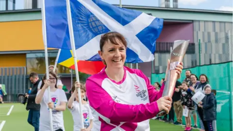 Getty Images Ailsa Polworth carries the baton at the Inverness Tennis and Squash club