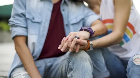 Getty Images Two unidentified women hold hands