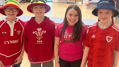 Osian, Deio, Megan and Ela tune up at Ysgol Pen Barras in Ruthin