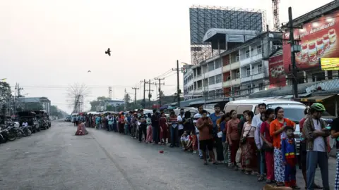 Getty Images Myanmar people queue to cross the Thailand-Myanmar Friendship Bridge to renew their 7-day pass in Mae Sot, Thailand on April 11, 2024. Myanmar ethnic rebels and civilian militia took over from the military forces the town of Myawaddy, a crucial trade hub near the Thai border.