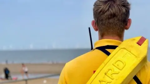 RNLI Lifeguard on beach in Skegness
