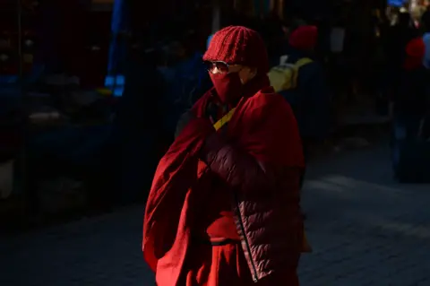 Getty Images Monk in McLeod Ganj wearing mask