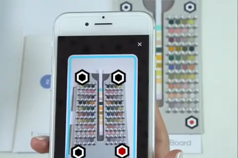 Healthy.io Phone scanning the colour chart containing the dipstick