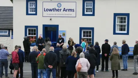 Lowther Arms Community Project A crowd gather outside the pub for the reopening