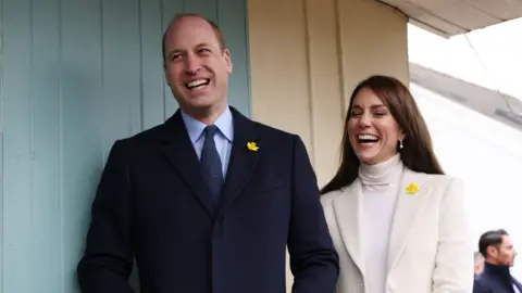 PA Media The royal couple laughing together during their visit