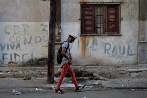 AFP A man walks along a street in Havana, 18 April