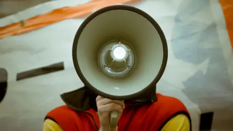 Alamy Person with megaphone