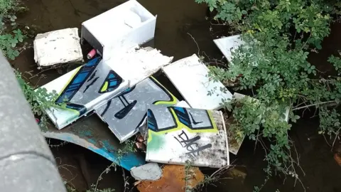 Lilliput Waste Disposal Ltd Fridges floating in water under bridge in Grimsby