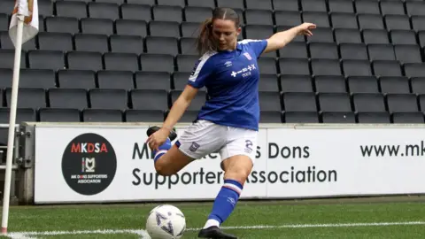 Ross Halls Maria Boswell, taking a corner at Stadium MK, the home of Milton Keynes Dons
