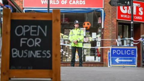 PA Open for business sign outside closed card shop