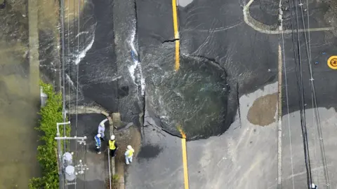 Reuters Cracked road flooded with water