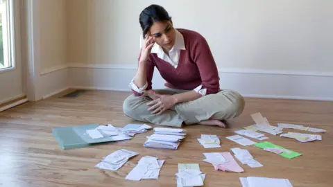 Getty Images woman surrounded by receipts