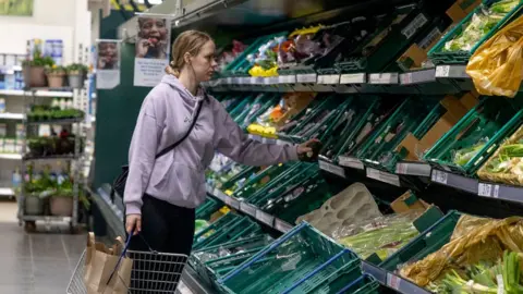 Getty Images Woman shopper in UK supermarket, 26 March 2022