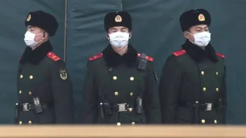 Getty Images Chinese policemen wearing masks