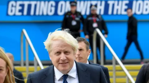 Reuters Prime Minister Boris Johnson walks through the Conservative Party annual conference venue in Manchester