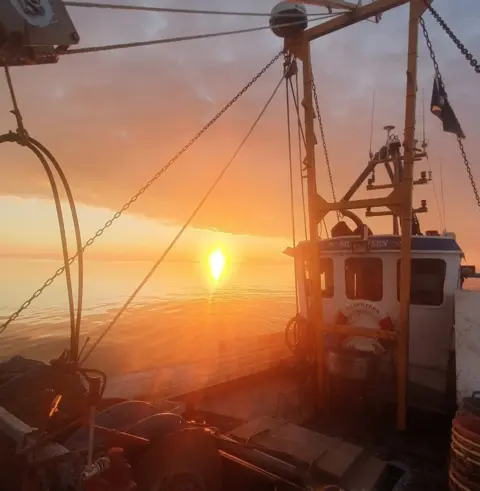 Charisma View of sunset on board at night