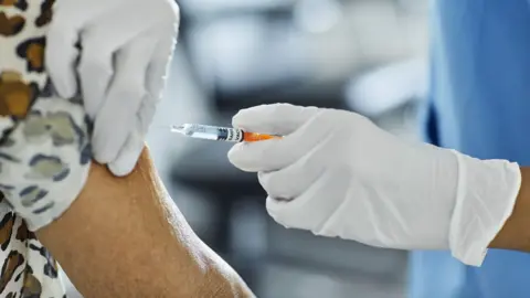 Getty Images Covid booster vaccines are being offered to 26 million people in England