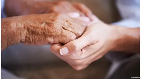 Getty Images Carer with patient