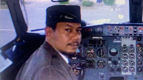 Endah Pilot Captain Afwan in the cockpit of a plane