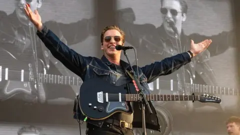 George Ezra smiling on stage