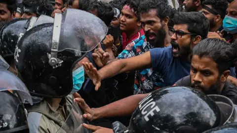 Getty Images Protestors near Sri Lanka's parliament building in Colombo.