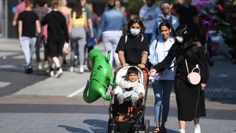 EPA People walk down the high street in Birmingham