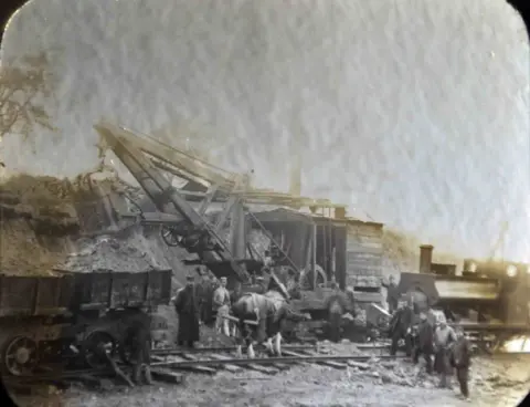 Scottish Water Steam engine showing a steam engine and horse used by workers to transport and move materials