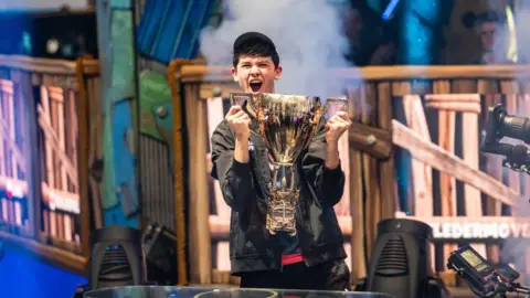 Getty Images Kyle 'Bugha' Giersdorf with the World Cup trophy