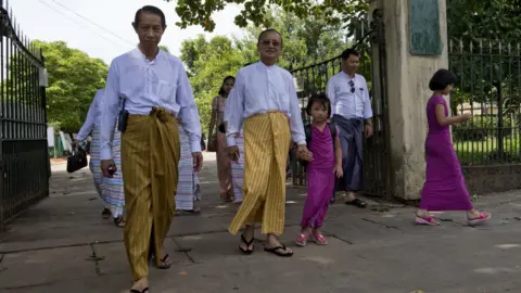 Getty Images Men wearing longyi in Myanmar (file image)