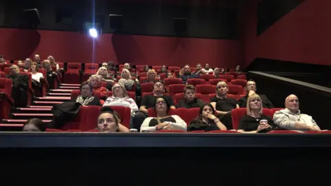 BBC People watching the Queen's funeral in a cinema