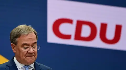 Getty Images The leader of Germany's conservative Christian Democratic Union (CDU) party and candidate for Chancellor Armin Laschet addresses a press conference following a CDU leadership meeting at the party's headquarters in Berlin on September 27,