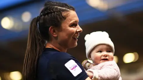 Getty Images Abbie Ward in rugby kit with her daughter Hallie