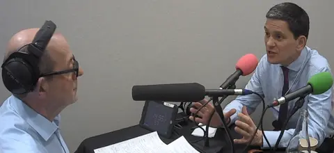 BBC David Miliband, left, speaks to the BBC's Nick Robinson