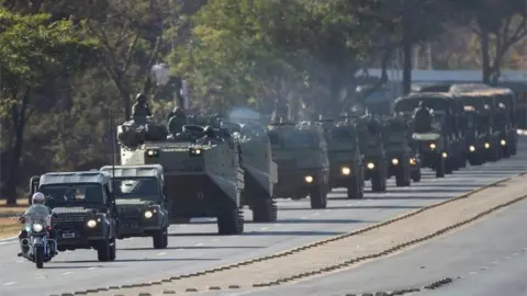 EPA A military convoy is seen at the main entrance of Esplanada dos Ministerios, in the city of Brasilia, Brazil, 10 August 2021
