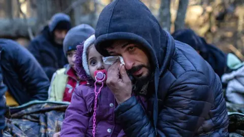 Getty Images A Kurdish family from Iraq near the Poland-Belarus border