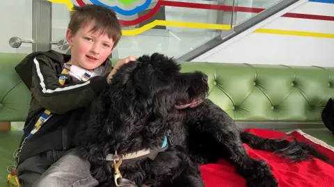 Joseph with his assistance dog Shadow